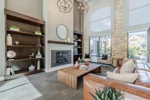 A modern living room with a fireplace and a large mirror on the wall.