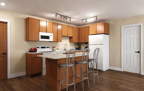 A kitchen with wooden cabinets and a white refrigerator.