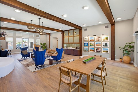 A modern dining room with a wooden table and chairs.