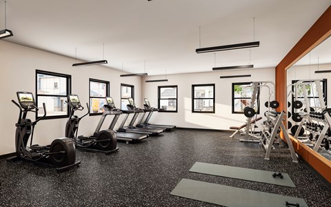 A gym with a row of treadmills and elliptical machines at Sidney Village, Buckeye, AZ