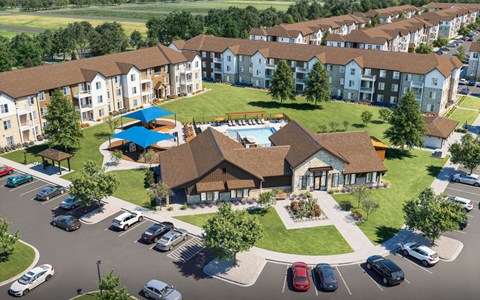 A large apartment complex with a pool and a clubhouse.