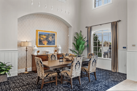 a dining room with a table and chairs and a window at Five 49 at River Oaks, Waxahachie, TX