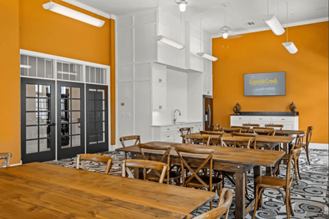 A kitchen area with a dining table and chairs.