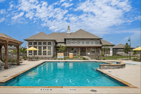 a large swimming pool in front of a house at Five 49 at River Oaks, Waxahachie, TX 75165
