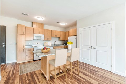 A kitchen with wooden floors and white walls. at Avery Landing Apartments, Greenville, SC