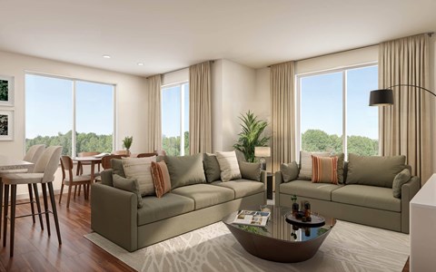 A modern living room with a large window and a view of trees outside.