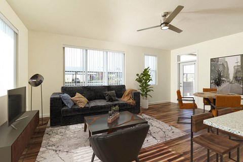 A living room with a black couch and a television.