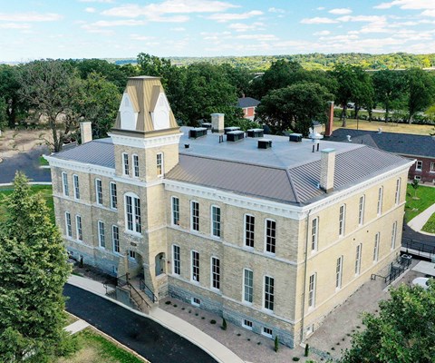 arial view of a large stone building with a towerat Upper Post Flats, Fort Snelling, MN 55111