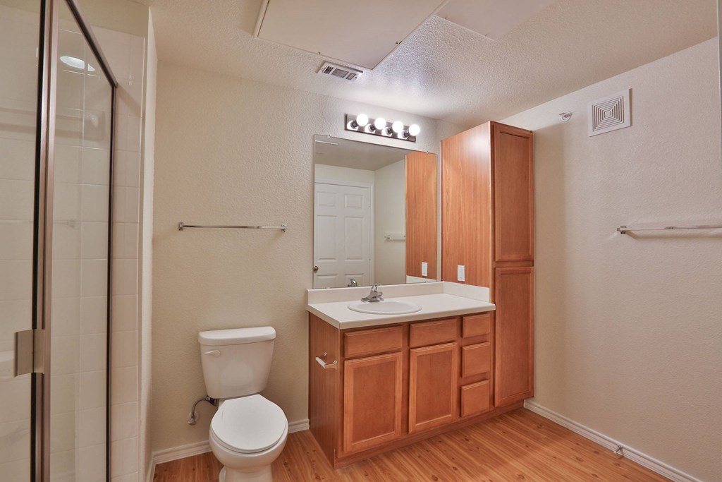 a bathroom with a sink toilet and a shower at Cedars of Elk Drive 55+ Apartments, Burleson Texas