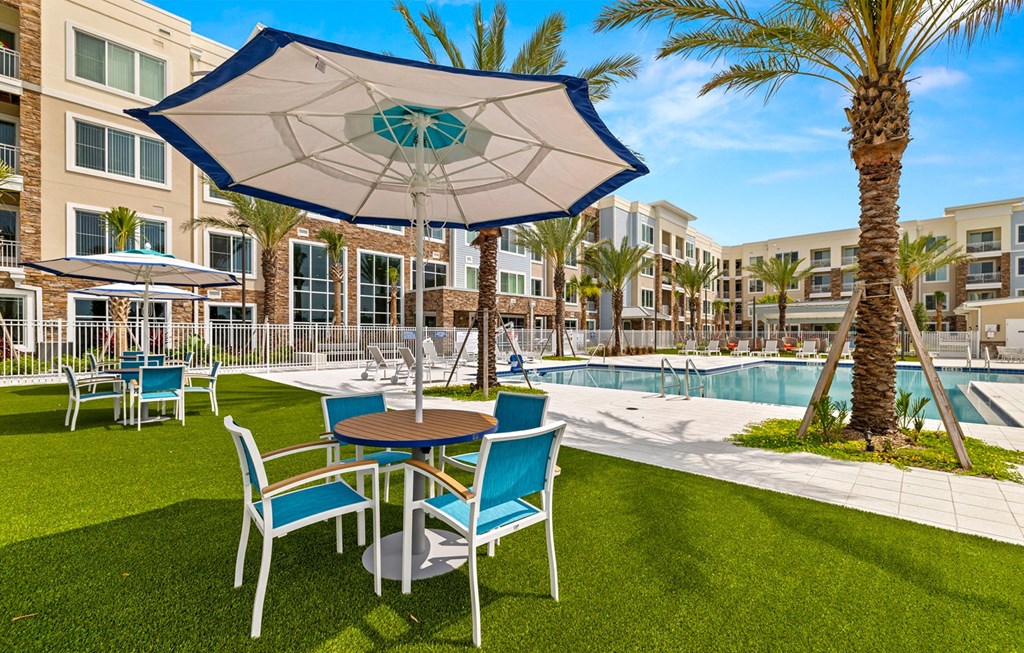 Pool and Lounge Tables at Osprey Park 62+ Apartments, Kissimmee, FL, 34758