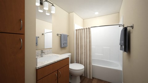 Bathroom with wood vanity and white fixtures at Turquoise Trail Apartments, Santa Fe