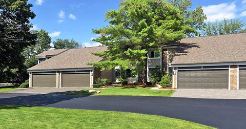 A wooded, beautifully landscaped community of townhomes with attached 2-car garages.