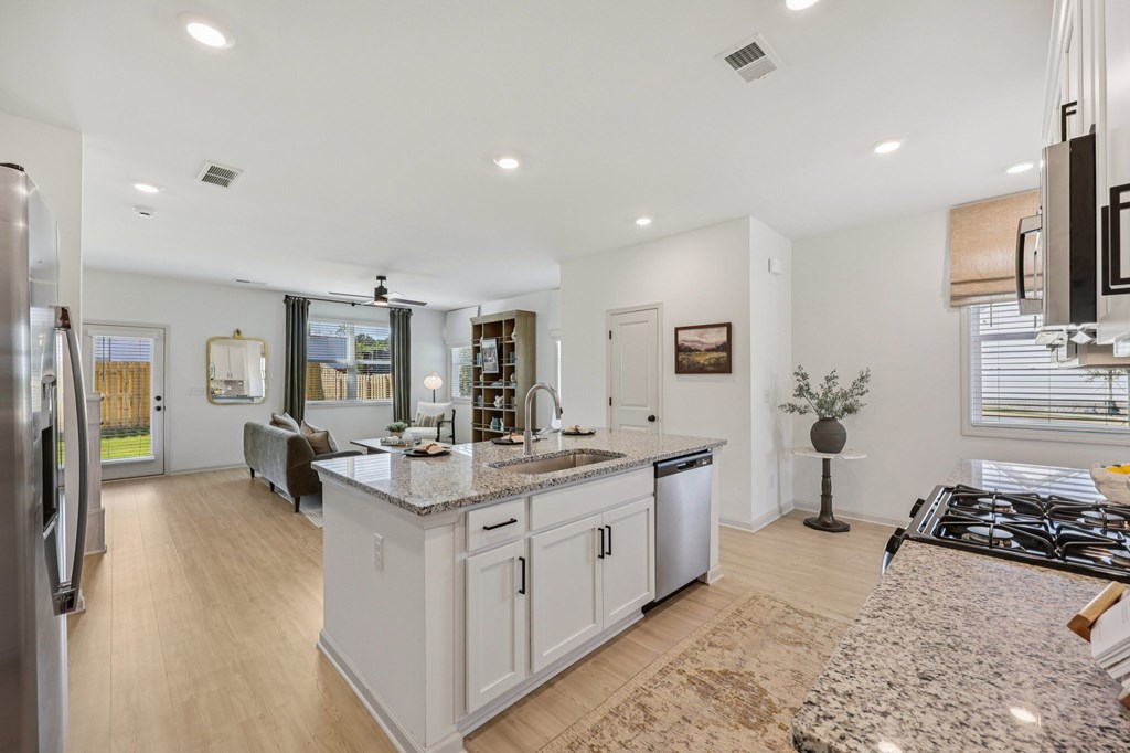 A modern kitchen with a large island and stainless steel appliances.