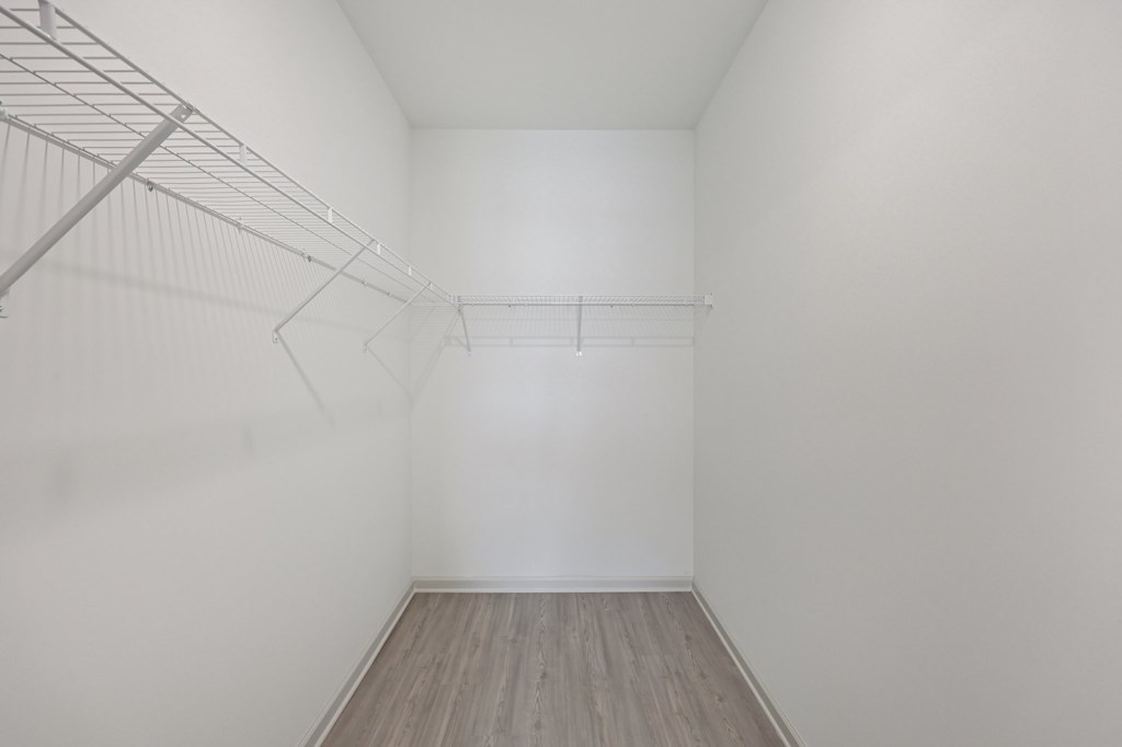 Empty room with a wooden floor and white walls.