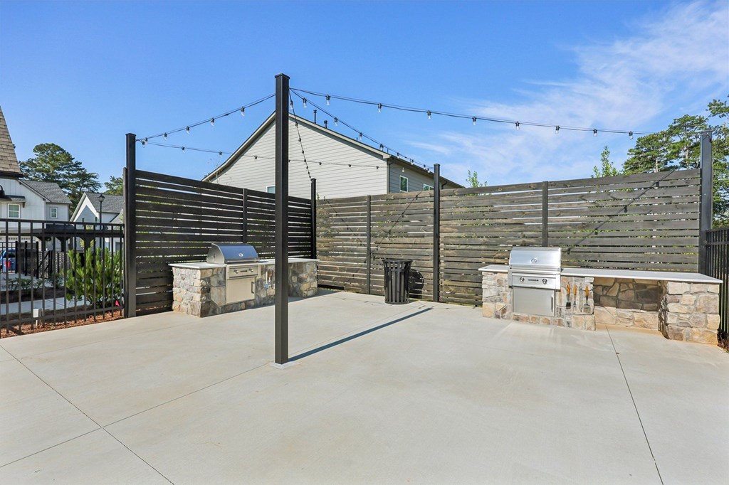 A driveway leads to a house with a gate and a mailbox.