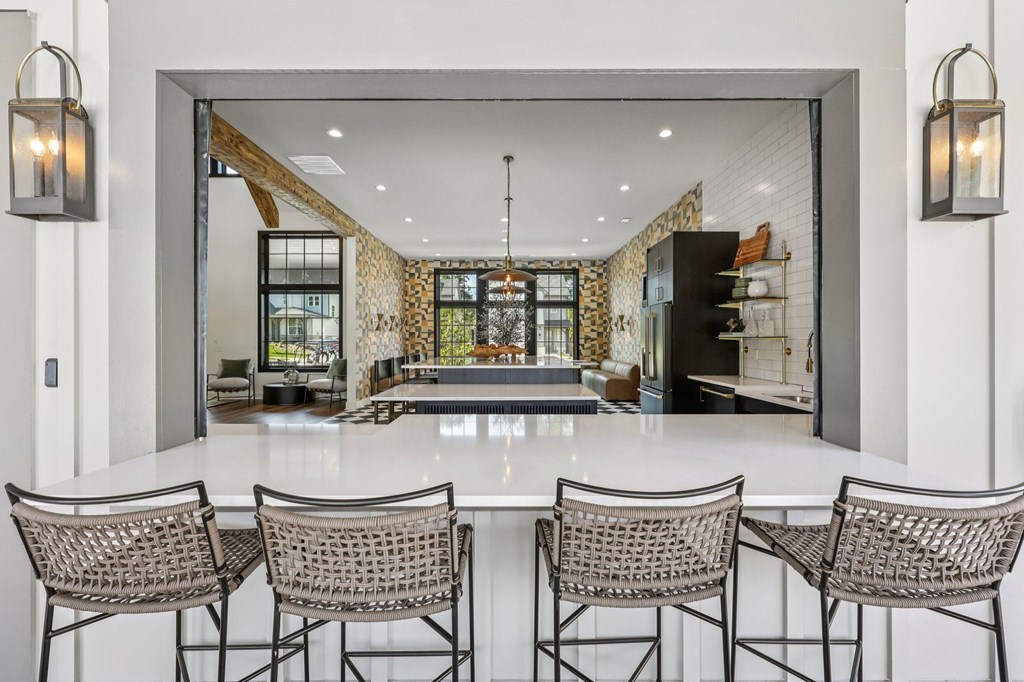 A dining room with a white table and chairs.