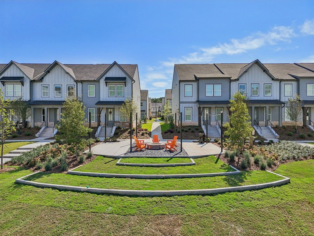 A row of houses with a garden in front.