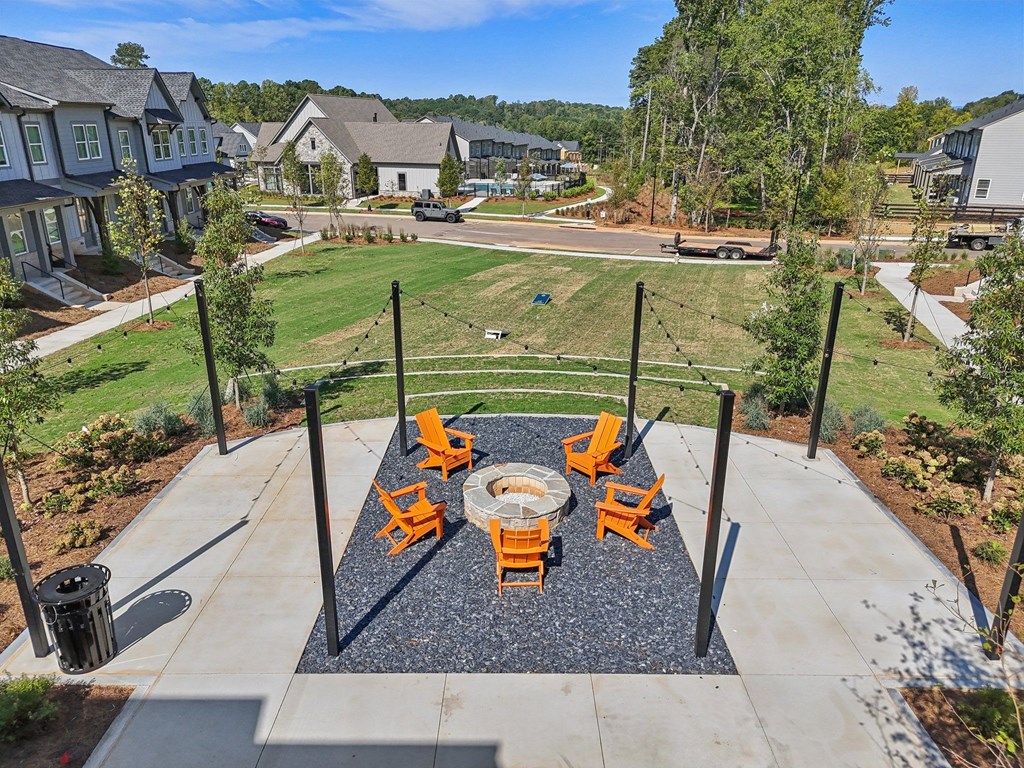 A patio with a table and chairs is surrounded by a black pole.