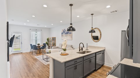 A modern kitchen with a dining table and chairs.