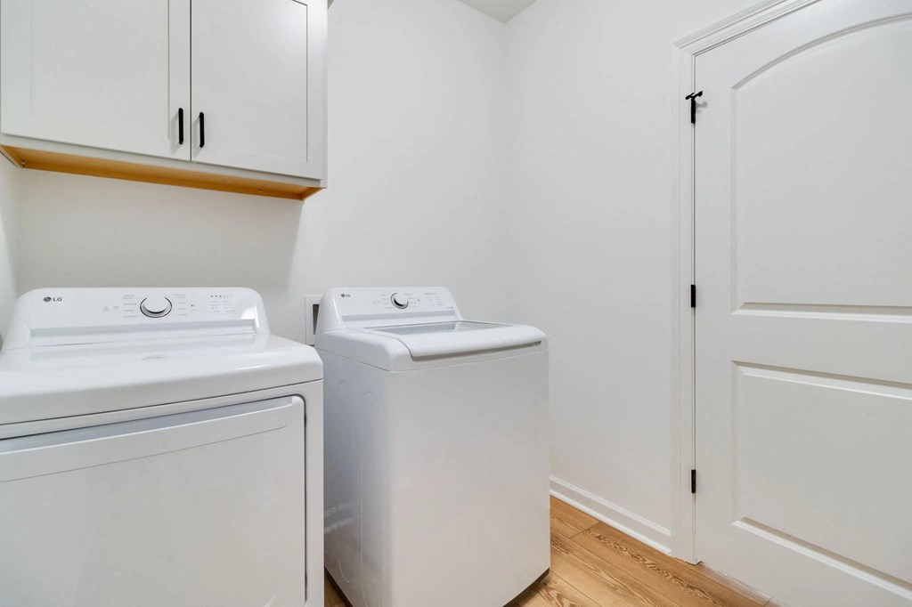 A white washing machine and dryer in a small laundry room.