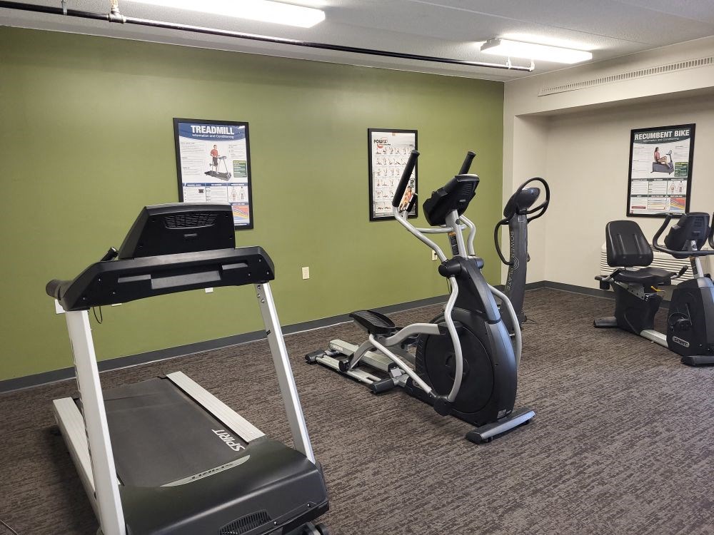a gym with a treadmill and other exercise equipment