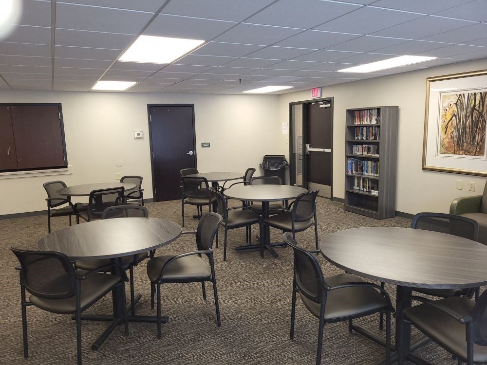a dining room with tables and chairs in a library