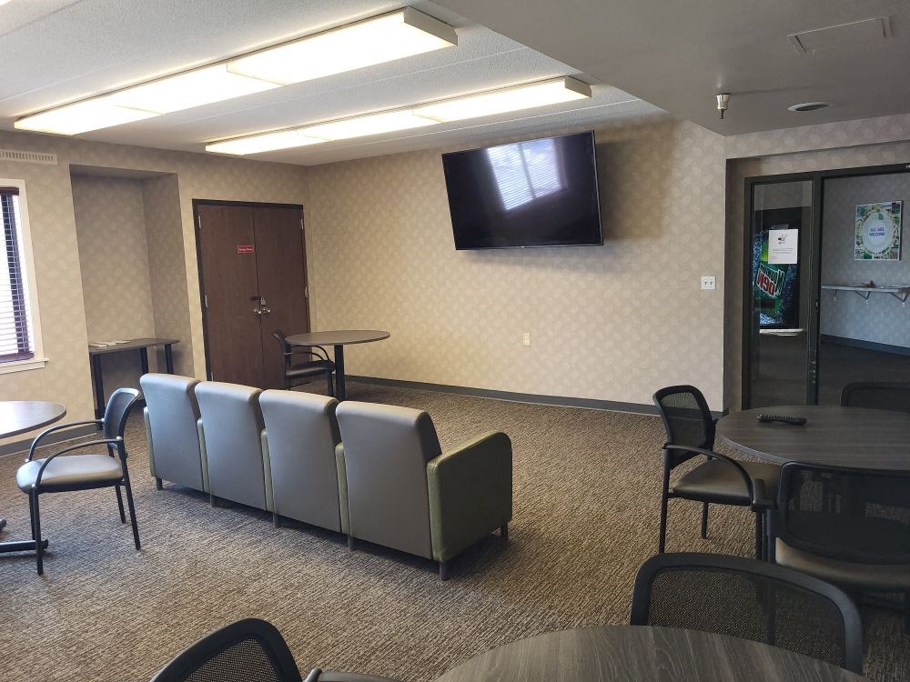 a conference room with chairs and a tv