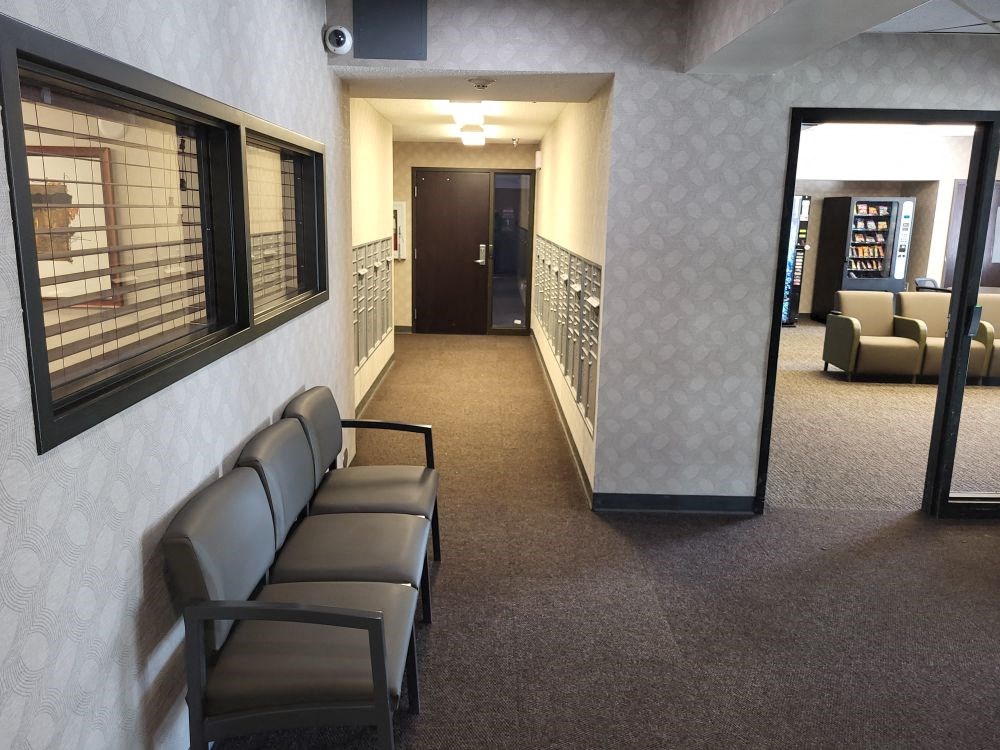 a waiting room in a hospital with chairs and a window