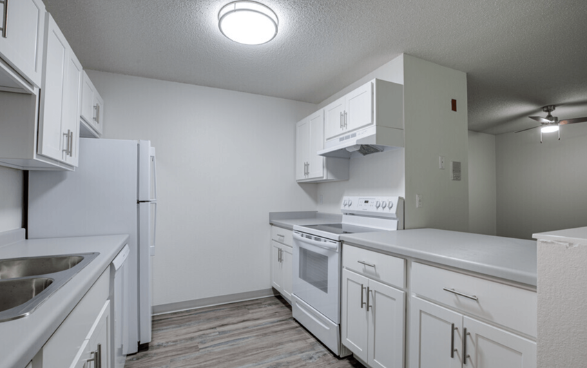 a white kitchen with white cabinets and white appliances