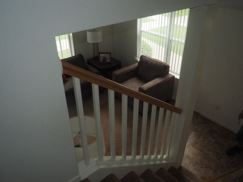 a living room is seen from the top of a staircase