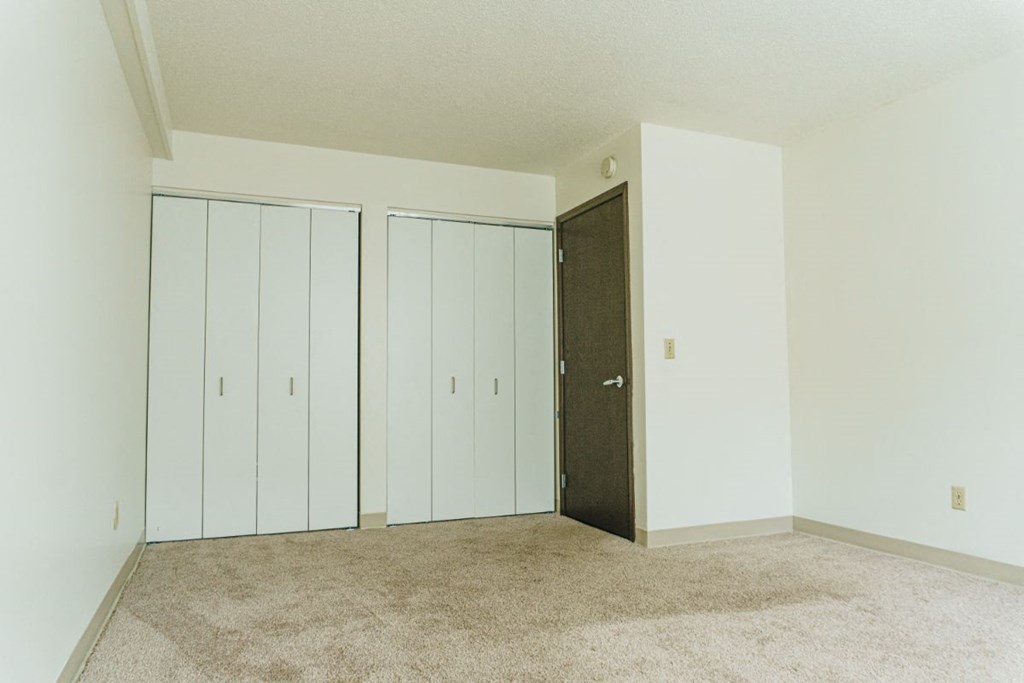 an empty room with three closets in it