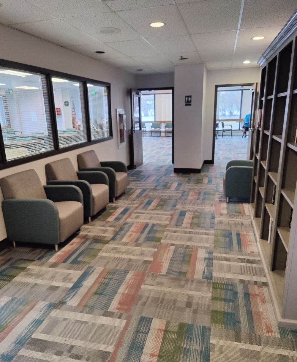 a view of a library with couches and chairs