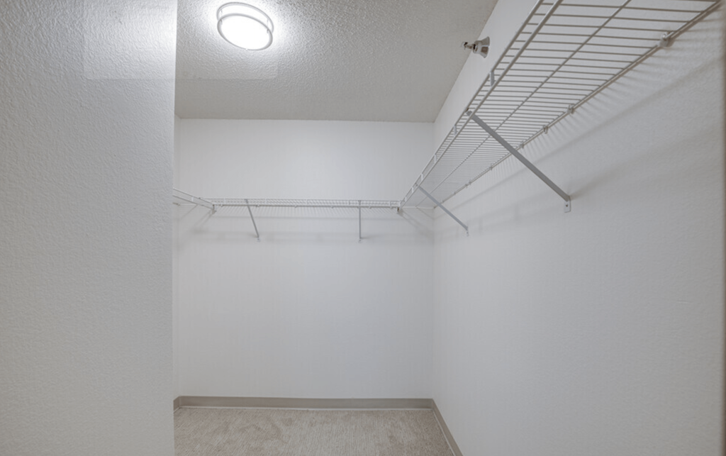 the interior of a room with white walls and a ceiling light