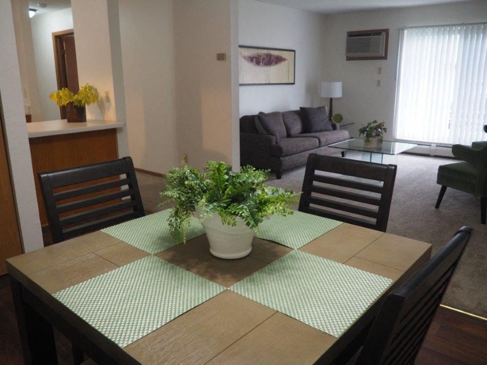 a dining room table with a potted plant on top of it