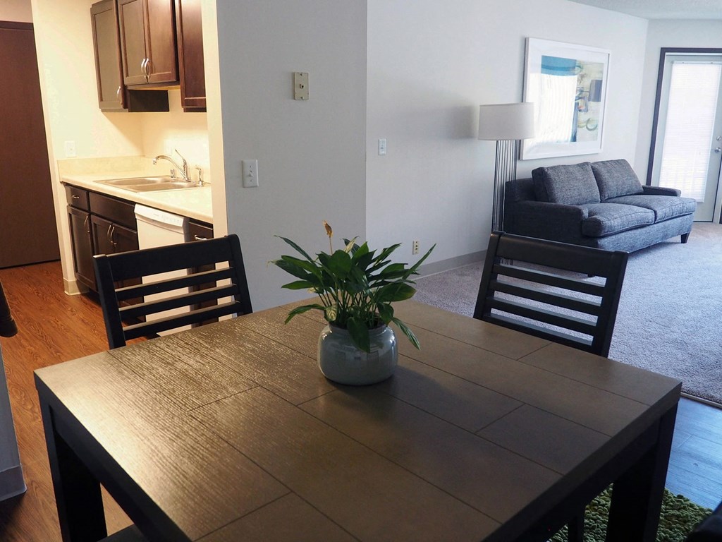 a dining room table with a potted plant in the middle