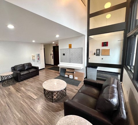 a living room with leather couches and tables