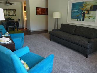 a living room with blue chairs and a couch