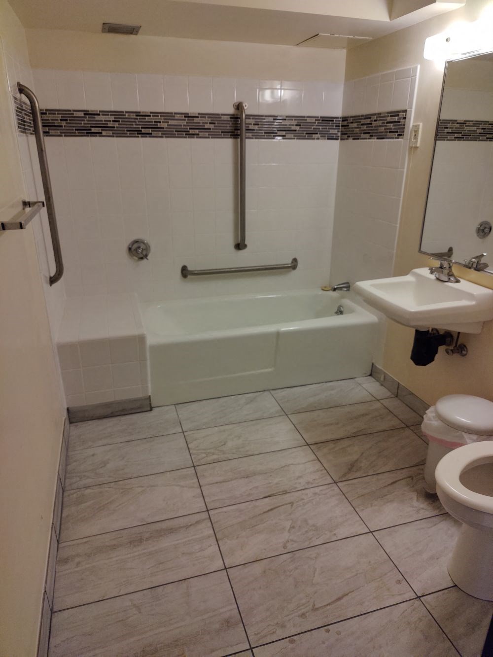 a bathroom with a tub and a toilet and a sink