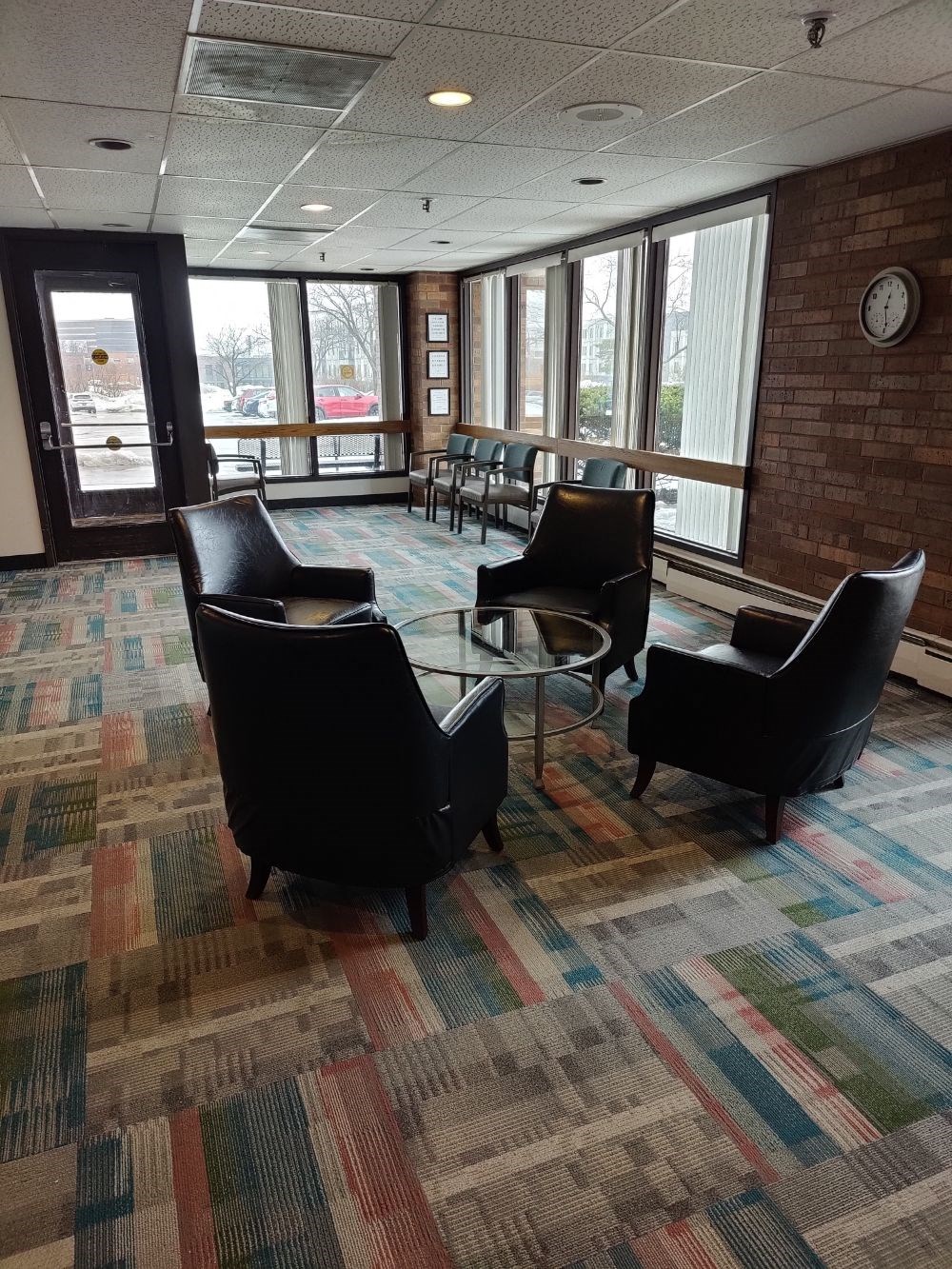 a large room with chairs and a glass table