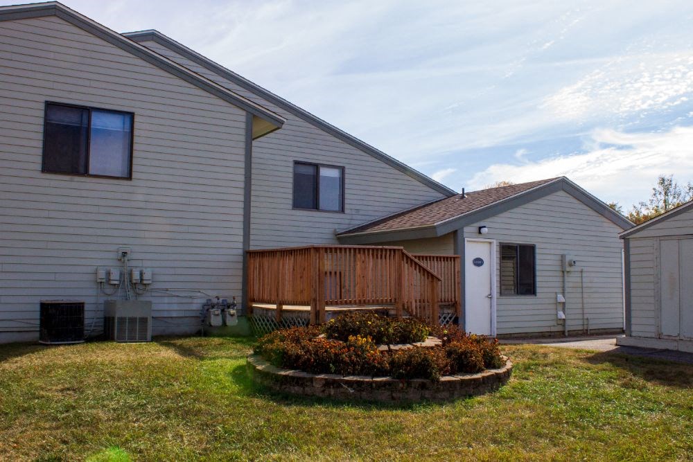 a backyard with a house and a wooden fence