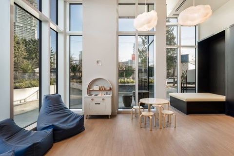 A modern living room with a blue bean bag chair and a white side table.
