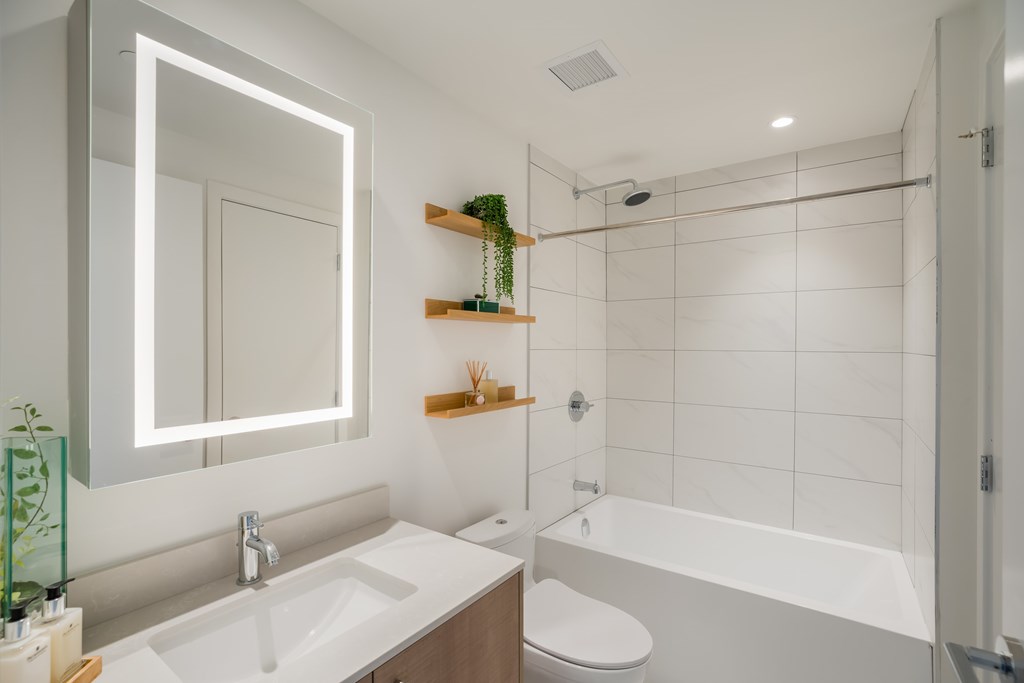 A white bathroom with a sink, toilet, and bathtub.