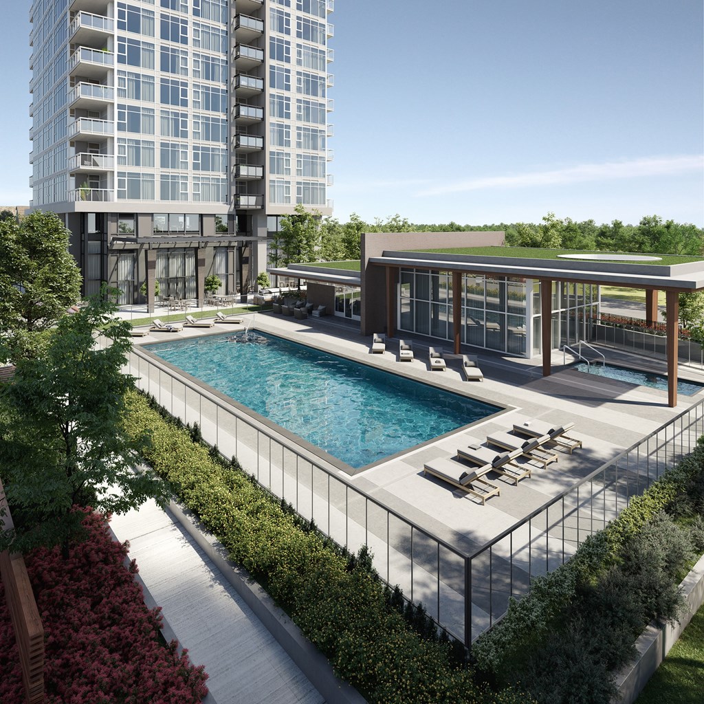 A modern building with a pool in front.