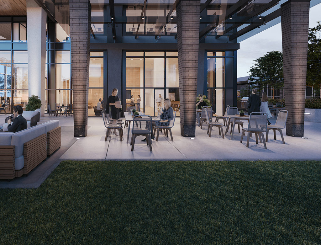 A modern outdoor seating area with people sitting and enjoying the view.