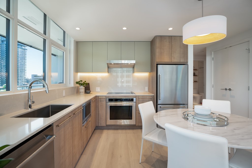 A modern kitchen with a dining table and chairs.