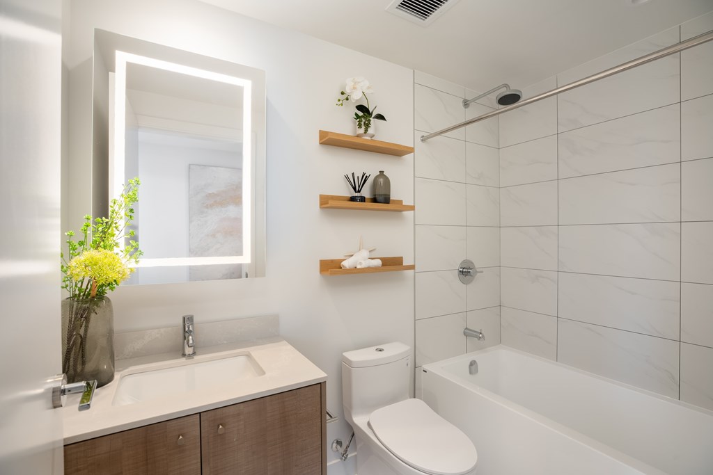 A white bathroom with a sink, toilet, and bathtub.