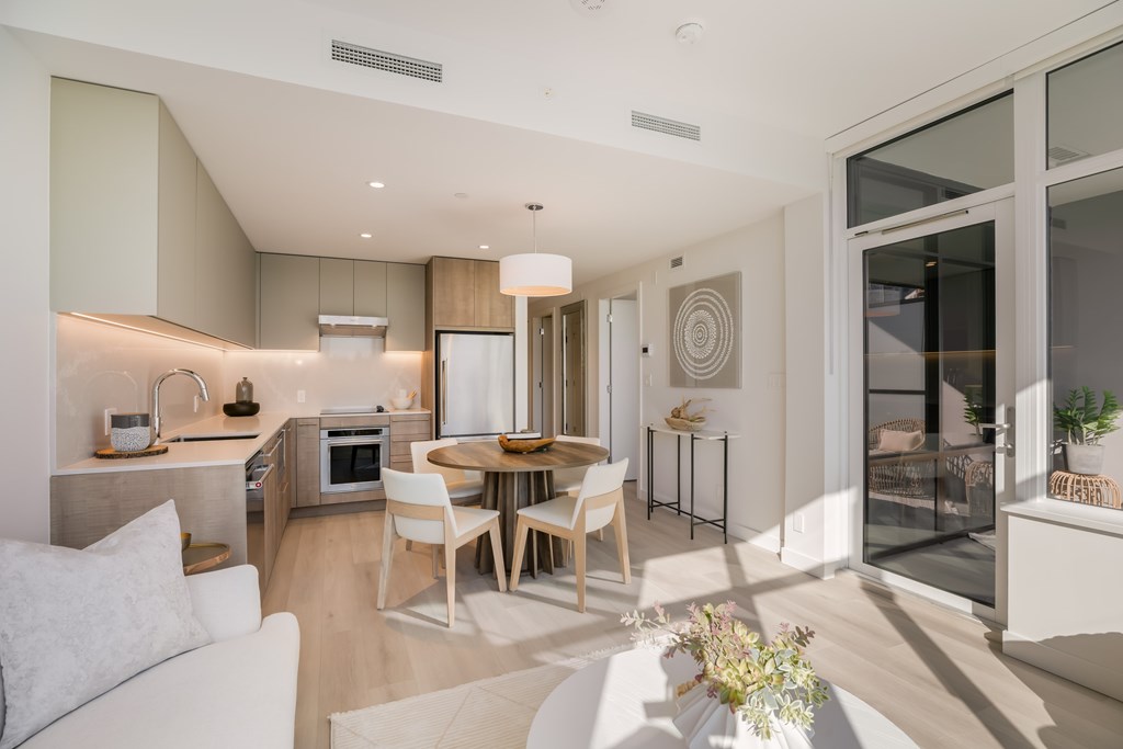 A modern kitchen with a dining table and chairs.