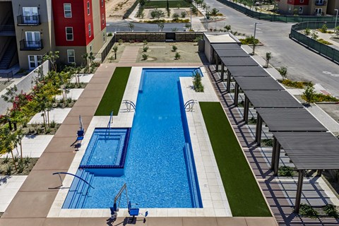A large blue swimming pool with a diving board.