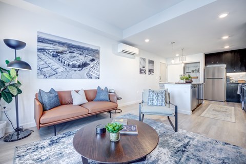 A living room with a brown couch and a coffee table.