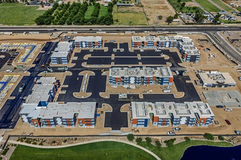 An aerial view of an apartment community with multiple buildings and roads.